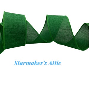 May include: Green wired ribbon with a textured, linen-like finish. The ribbon is curled and twisted, showing the texture and color.
