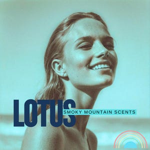 May include: A woman with long blonde hair smiles while looking up. The text "LOTUS SMOKY MOUNTAIN SCENTS" is in the foreground. A rainbow with a blue sky is in the background.