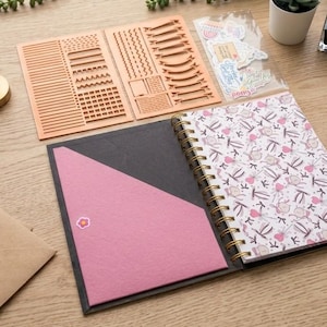 May include: A white ceramic mug with a black handle and the text "But First, Coffee" in a black, handwritten-style font. The mug is on a white surface.