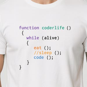May include: White t-shirt featuring the text "function coderlife () { while (alive) { eat (); //sleep (); code (); } }" in a colourful font. The shirt has a crew neck design.