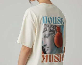 May include: An off-white short-sleeve t-shirt featuring a graphic on the back. The design includes the text HOUSE MUSIC in blue and orange, surrounding a classical marble-style bust wearing large orange headphones over the ears.