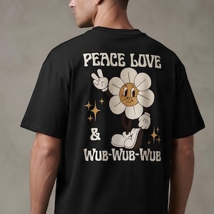 May include: A black short-sleeved t-shirt featuring a graphic on the back. The design shows a cartoon flower character making a peace sign, surrounded by four-pointed stars. The text reads PEACE LOVE & WUB-WUB-WUB in a bold, retro-style font.
