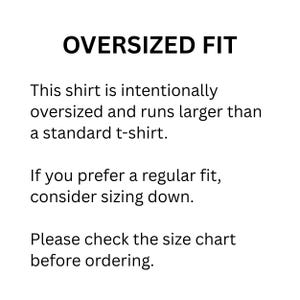 May include: A white informational graphic with black text that reads: OVERSIZED FIT. This shirt is intentionally oversized and runs larger than a standard t-shirt. If you prefer a regular fit, consider sizing down. Please check the size chart before ordering.