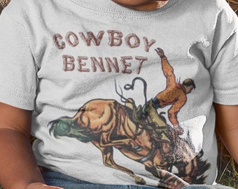 Individuelles Retro Bucking Bronco Buckaroo Cowboy Shirt mit beigem Schriftzug. Personalisierte Jungen Geburtstag Cowboy Rodeo Shirt. Geschenk für Junge.