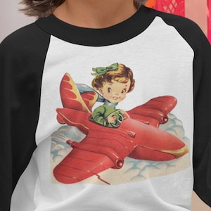 Retro Pilot Girl Airplane Shirt. Retro Raglan Shirt. Girl Pilot in Red Plane. Vintage Graphic T Shirt. Choose size 3 months to 12 years.