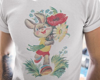 May include: White t-shirt with a vintage illustration of a cartoon bunny holding a bouquet of flowers. The flowers include a red poppy, a white daisy, and blue forget-me-nots.