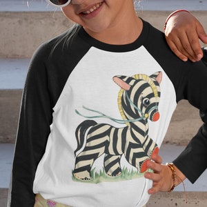 Retro Kitsch Zebra Raglan Shirt. Classic baseball shirt with kitschy cute little zebra stuffy toy with blue ribbon.