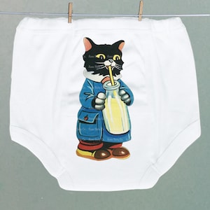 May include: White baby onesie with a cartoon cat illustration. The cat is black with yellow eyes and is wearing a blue coat, holding a bottle with a yellow liquid and a straw. The onesie is hanging from a clothesline.