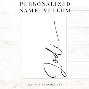 May include: A white vellum paper with the name "Jodi" written in elegant black script. The text "PERSONALIZED NAME VELLUM" is at the top, and "JAMISON REID DESIGNS" is at the bottom.