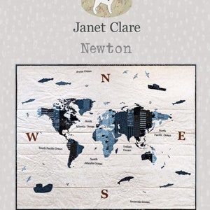 May include: A quilted world map with blue and black continents on a white background. The quilt measures 44 x 36 inches. The design includes fish, birds, and ships. The text "Janet Clare Newton" is at the top.