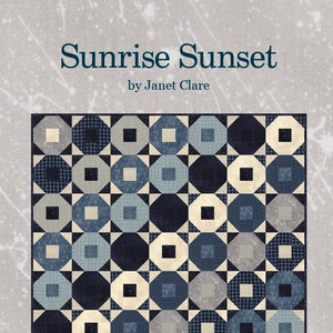 Op de afbeelding: Een quiltpatroon genaamd "Sunrise Sunset" van Janet Clare. De quilt is gemaakt van een herhalend patroon van achthoeken en vierkanten in tinten blauw, grijs en wit. De afgewerkte quilt meet 63 inch bij 63 inch.
