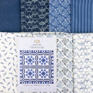 May include: An assortment of blue and white fabric samples featuring floral, teapot, and striped patterns. A booklet in the centre is titled "Janet Clare Victoria", with finished quilt dimensions of 178 x 178 cm.