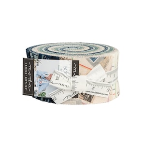 May include: Moda Fabrics & Supplies roll of fabric featuring a blue and white patterned design with the text "Moda Fabrics" and "www.modafabrics.com".