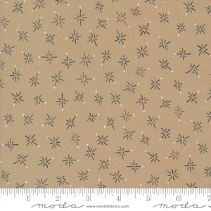 Pode incluir: Um tecido bege com um padrão repetitivo de pequenas estrelas cinzas escuras. O tecido é mostrado com uma régua para escala.