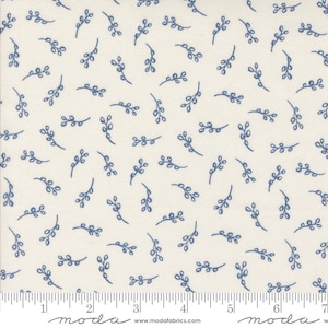 May include: Cream-colored fabric with a repeating pattern of small, blue, stylized sprigs. The sprigs are evenly distributed across the fabric. The fabric has a ruler printed along the bottom edge. The brand name "moda" is printed on the bottom left and right.