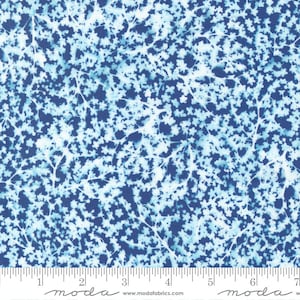 May include: Blue fabric with a white floral pattern. The fabric has a subtle, faded look, giving it a vintage feel. The pattern is made up of small, delicate flowers and branches.