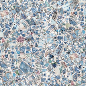 May include: A mosaic pattern made from broken blue and white ceramic pieces. The fragments, of various sizes and shapes, are set against a white background. Some pieces display floral and patterned designs.