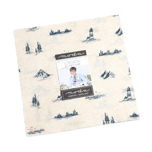 May include: A cream-coloured fabric with a blue and white print of lighthouses, mountains, and cityscapes. The fabric is labelled "Longshore by Janet Clare" and "Moda Fabrics + Supplies".