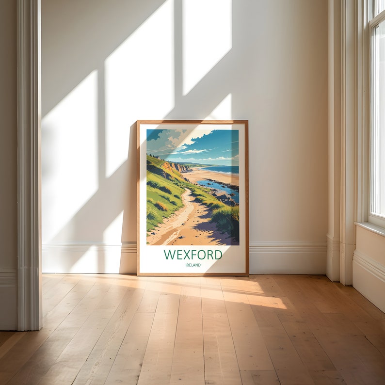 May include: A framed art print featuring a coastal landscape with a path leading to the beach. The artwork showcases a vibrant scene with green hills, a sandy path, and a blue ocean under a bright sky. The text "WEXFORD IRELAND" is at the bottom.