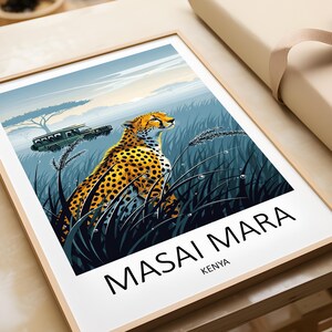 May include: A framed art print featuring a cheetah in a grassy field with a safari vehicle in the background. The print has the words "MASAI MARA" and "KENYA" in black text. The cheetah has yellow fur with black spots.