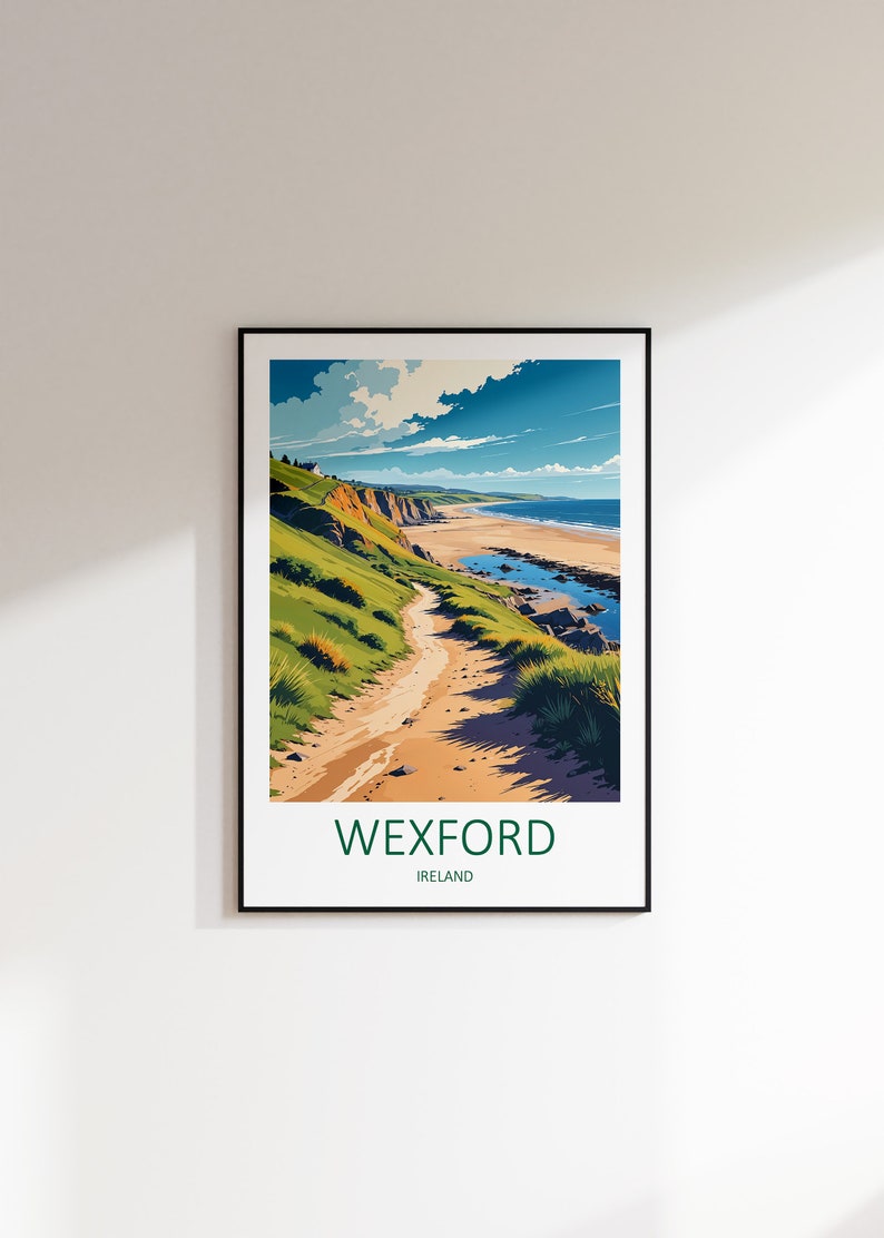 May include: A framed art print featuring a coastal landscape with a sandy path leading to a beach. The artwork depicts green hills, blue water, and a bright sky. The text "WEXFORD IRELAND" is at the bottom.