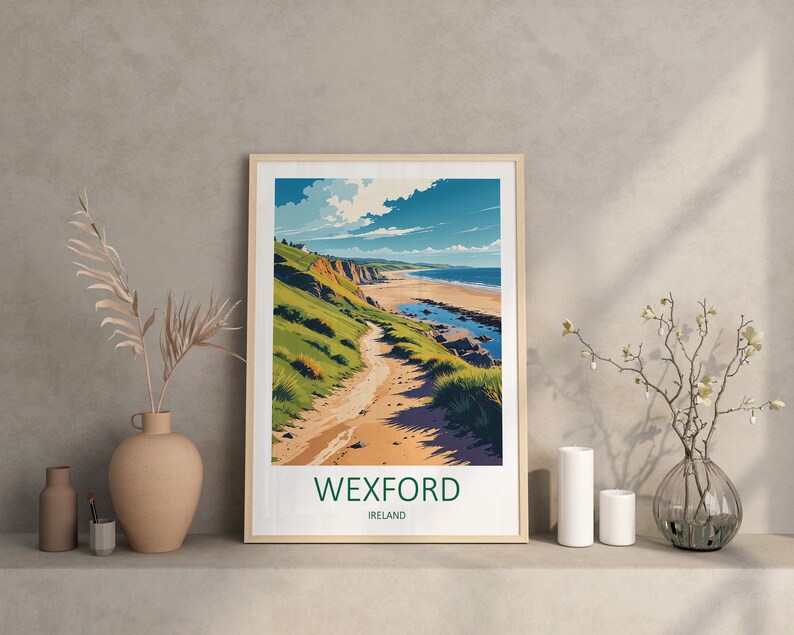 May include: Framed art print featuring a coastal landscape with a path leading to a beach. The artwork showcases a vibrant scene with green hills, a sandy beach, and a blue sky with clouds. The text "WEXFORD IRELAND" is at the bottom.