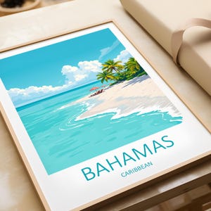 May include: A framed print of a tropical island scene with palm trees, a white sandy beach, and turquoise blue water. The text "BAHAMAS CARIBBEAN" is printed at the bottom of the print.