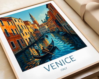 May include: Framed art print of Venice, Italy, featuring a canal scene with gondolas and colorful buildings. The artwork has a vibrant color palette of blues, oranges, and yellows. The word "VENICE" is printed in large blue letters at the bottom.