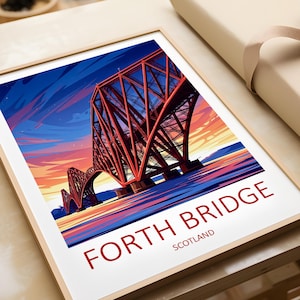 May include: Framed print of the Forth Bridge in Scotland. The image features a stylized illustration of the red bridge against a colorful sunset sky. The words "FORTH BRIDGE" and "SCOTLAND" are printed in red at the bottom.