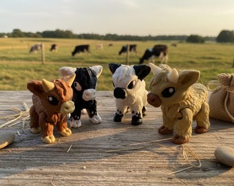 May include: Four toy Highland cows in various colors: brown, black and white, and tan. They are posed on a wooden surface with a blurred background of a field and grazing cows. A small burlap sack is also present.