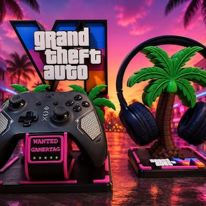 May include: A black gaming controller on a pink and black stand labeled WANTED GAMERTAG, next to a black headset on a palm tree stand with a Grand Theft Auto VI logo. The setup features a vibrant neon-lit city street background.