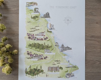 May include: A watercolor map titled THE YORKSHIRE COAST, featuring green landscapes, blue water, and detailed illustrations of landmarks like Whitby, Robin Hood's Bay, and Scarborough. A compass rose is included on the right side of the print.
