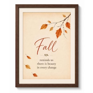 May include: A framed wall art print featuring a cream-colored background with a brown wooden frame. The text reads Fall reminds us there is beauty in every change. A branch with orange and brown autumn leaves extends from the top right corner.