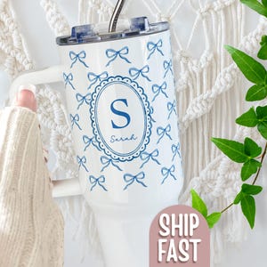 May include: A white ceramic mug with a black handle and the text "But First, Coffee" in a handwritten style. The mug is on a white surface. The mug is 4 inches tall.