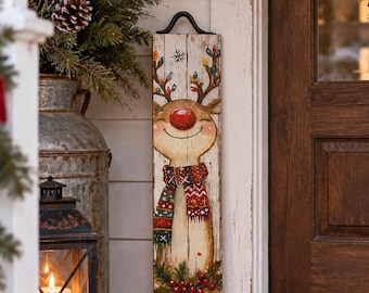 May include: A tall, rectangular wooden sign with a distressed white finish featuring a painted reindeer with a bright red nose, a patterned scarf, and antlers decorated with colourful Christmas lights, topped with a black metal handle.