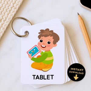 May include: A flashcard with a cartoon child holding a tablet. The word "TABLET" is printed in black at the bottom. The flashcards are held together by a metal ring. A black circle with the words "INSTANT DOWNLOAD" is in the corner.