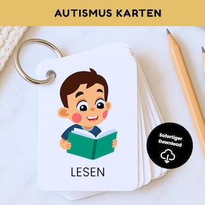May include: A set of flashcards with a metal ring, featuring a cartoon illustration of a child reading a green book. The word "LESEN" is printed below the image. The top of the cards reads "AUTISMUS KARTEN". A black circle with the words "Sofortiger Download" is also visible.