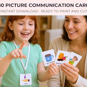 May include: A young girl and an adult are holding picture communication cards. The cards feature illustrations of a mug of hot chocolate, snack time, and a child with a computer. The text "480 PICTURE COMMUNICATION CARDS" is at the top.