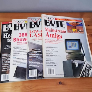 May include: A collection of four vintage BYTE computer magazines from 1990, featuring bold black and red typography, technical headlines, and cover illustrations of computer hardware, including an Amiga monitor, keyboard, and mouse.