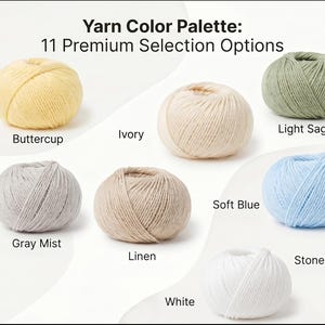 May include: A yarn colour palette featuring 11 premium selection options in balls of yarn labelled Black, Buttercup, Ivory, Light Sage, Navy, Dark County Blue, Gray Mist, Linen, Soft Blue, Stonewash, and White, arranged on a white background.