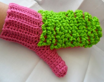 May include: A pink and green crocheted mitten with a textured design. The mitten is made with a combination of single crochet and double crochet stitches.