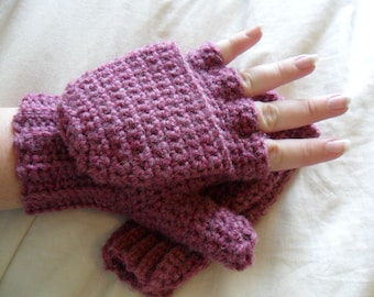 May include: A pair of fingerless gloves in a deep purple color, crocheted with a textured stitch. The gloves are shown on a hand with the fingers extended.