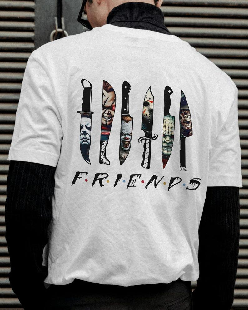 May include: White t-shirt with a graphic of seven knives, each with a different horror movie character's face on the blade. The text "FRIENDS" is printed below the knives.