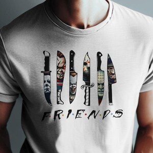 May include: White t-shirt with a graphic of knives with horror movie characters' faces on them. The text "FRIENDS" is below the knives.