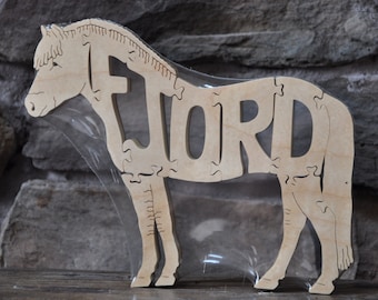 May include: A wooden horse jigsaw puzzle with the word "FORD" cut out of the body. The puzzle is packaged in clear plastic.