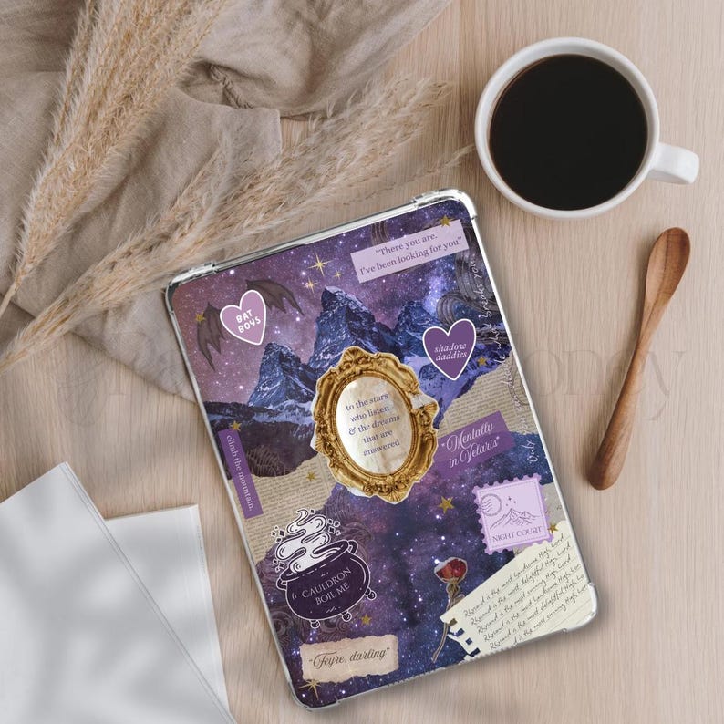 May include: A clear tablet case with a collage design featuring a purple night sky, mountains, and various stickers. The stickers include hearts, a cauldron, and text such as "Bat Boys" and "Shadow Daddies". A cup of coffee and a wooden spoon are also visible.