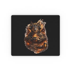 May include: Black rectangular mousepad featuring a dragon-like creature wearing headphones and holding a game controller. The dragon is surrounded by flames and sparks. A battery and a charging cable are also visible.