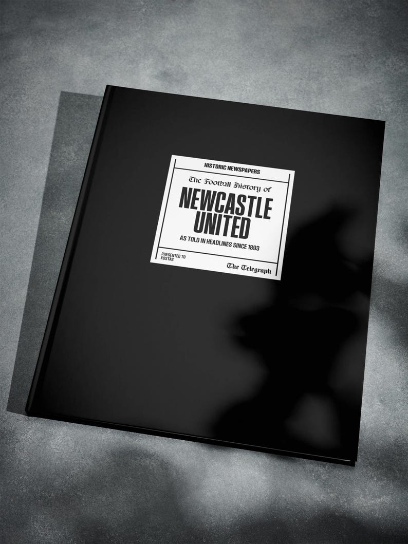 May include: A black book with a white label that reads "HISTORIC NEWSPAPERS The Football History of NEWCASTLE UNITED AS TOLD IN HEADLINES SINCE 1883 PRESENTED TO KOSTAS The Telegraph"
