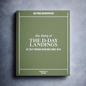 May include: A green book titled "The Story of The D-Day Landings" with the subtitle "As Told Through Headlines Since 1944". The book is presented to Stephen.