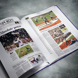 May include: An open newspaper with a sports section featuring a photo of a football player holding up a trophy. The headline reads "Absolute power".